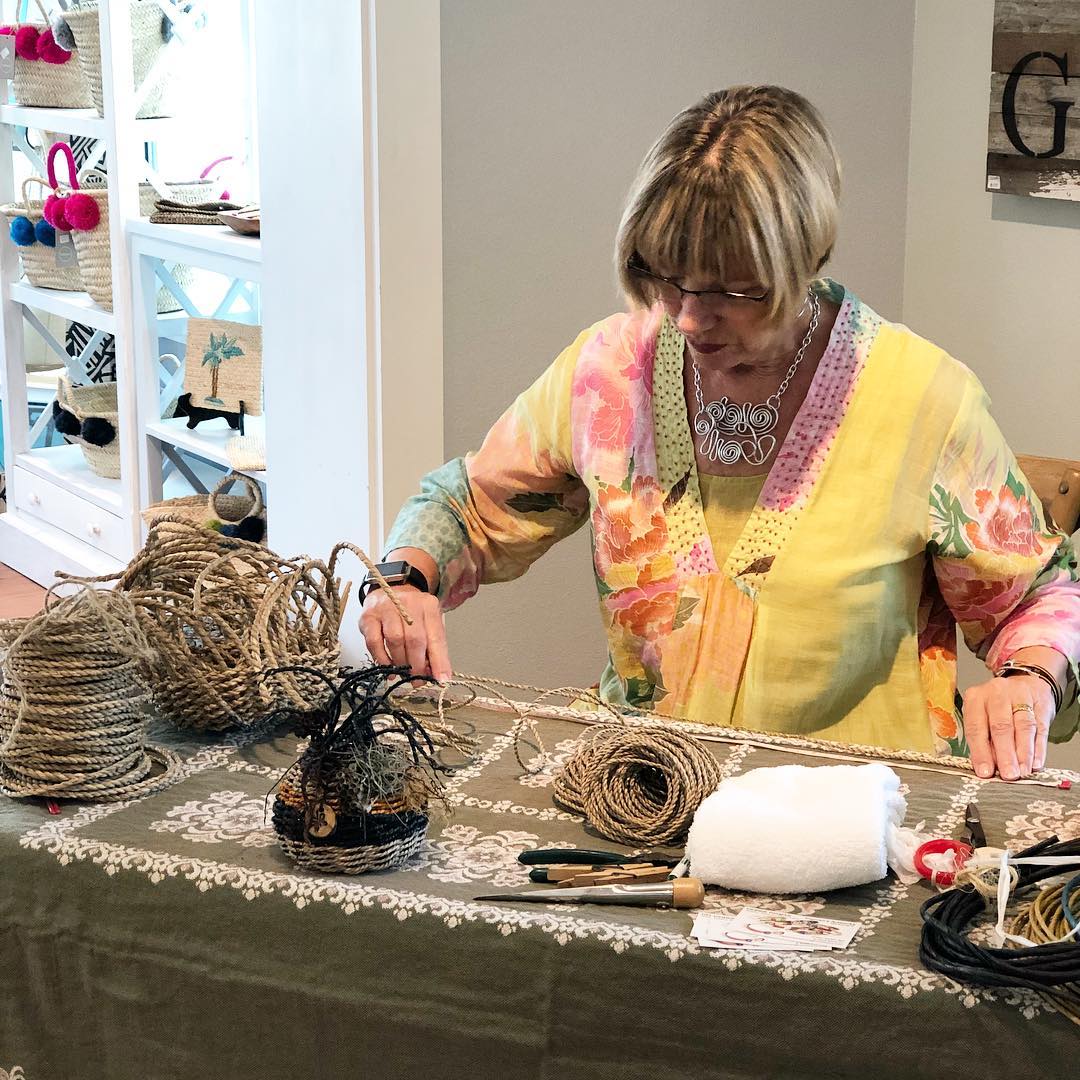 Woman measuring knitted cord.